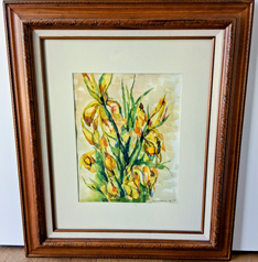 Framed artwork featuring yellow flowers and green foliage