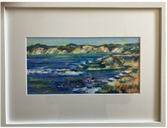 Framed painting of a rocky coastline and blue ocean